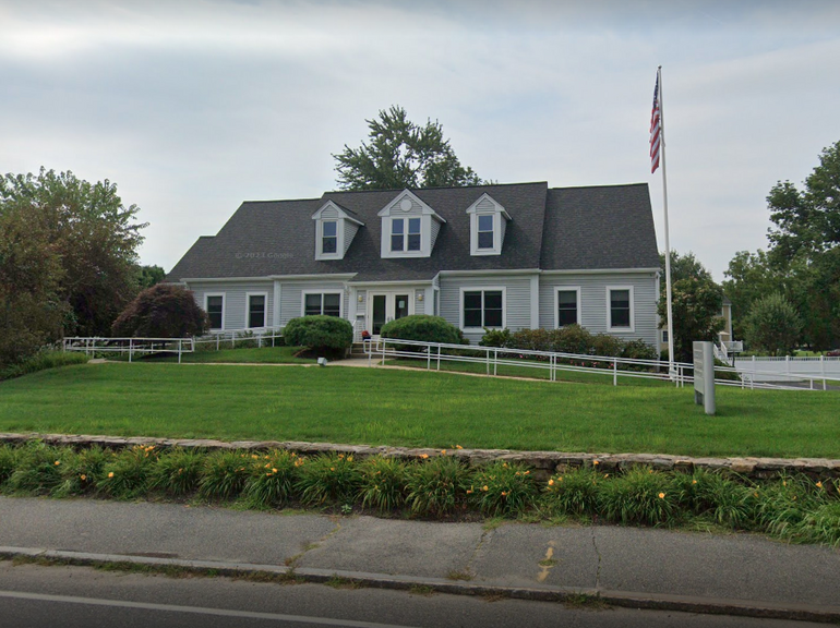 A small building with a lawn in front