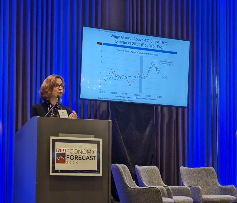 A woman speaks at a podium