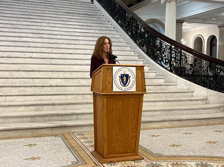 A woman speaks at a podium