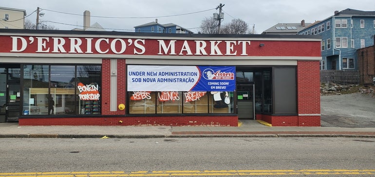 A retail storefront with a banner over a window