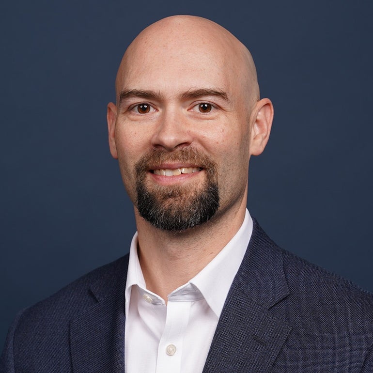 a portrait photo of a man in a suit