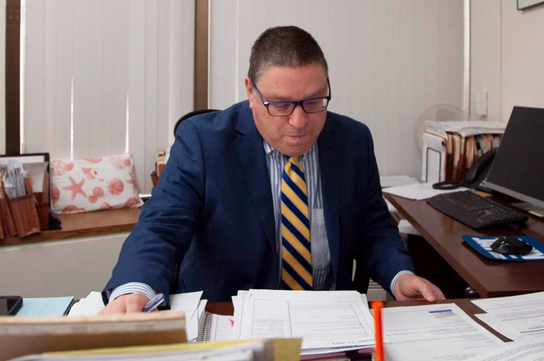 Inspector General Jeffrey Shapiro looks over paperwork in an office