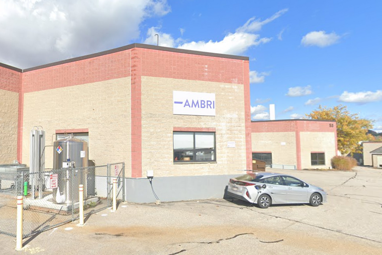 An industrial building with a EV charging in front