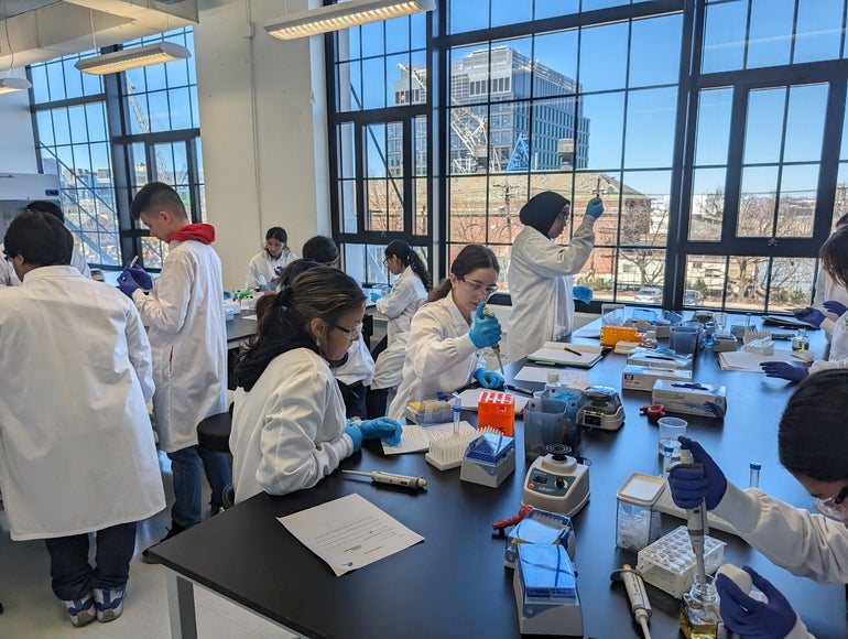 A group of high school students in a lab