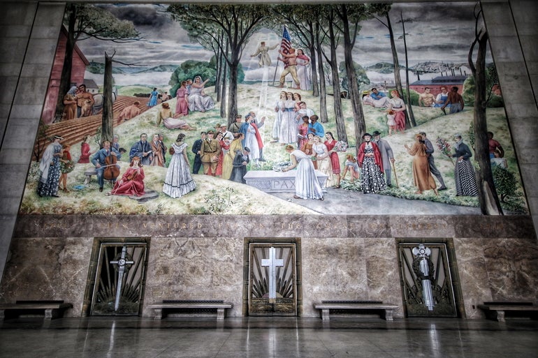 A large painting of people on a hilltop sits on a marble wall with marble flooring beneath.