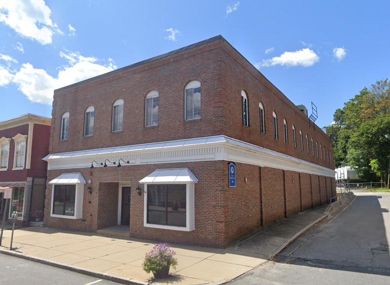 A two-story brick building in a suburban downtown.