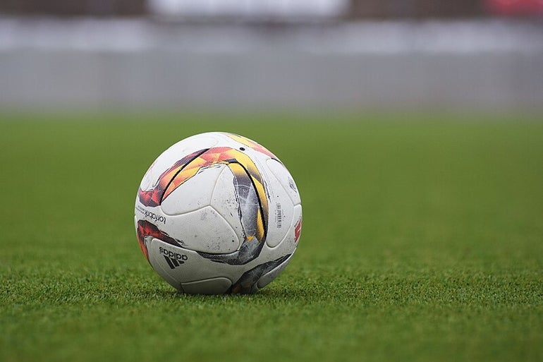 A soccer ball sits in a field