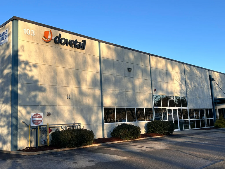 A grey industrial building with a Dovetail logo on it