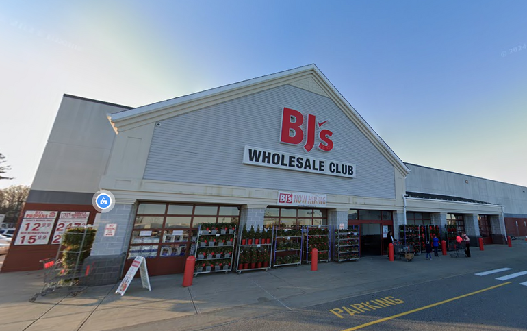The storefront of a large retail building with a BJ's Wholesale Club in front.