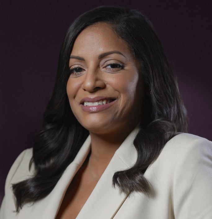 A woman in a beige suit