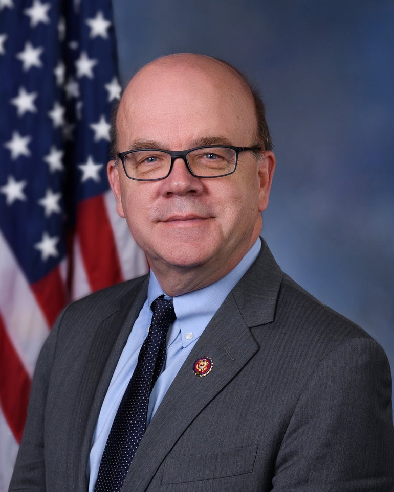 Man in suit in front of American flag