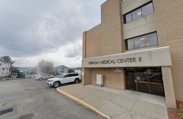 A medical office building with residential buildings behind it