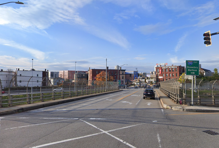 A bridge with cityscape behind it