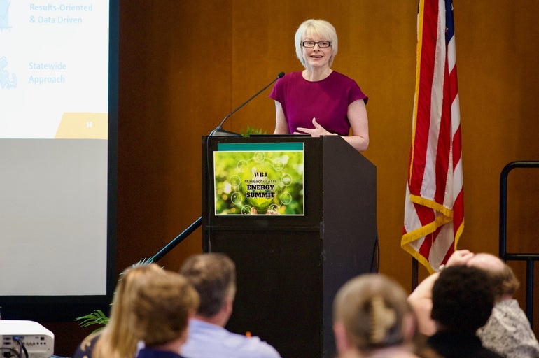 Woman at podium speaking