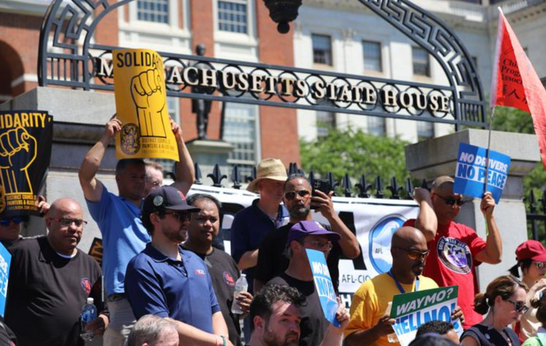 Group of union protesters hold signs 