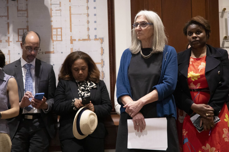 Four people standing in business attire