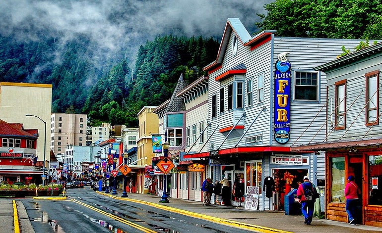 Downtown of small city showing shops and pedestrians