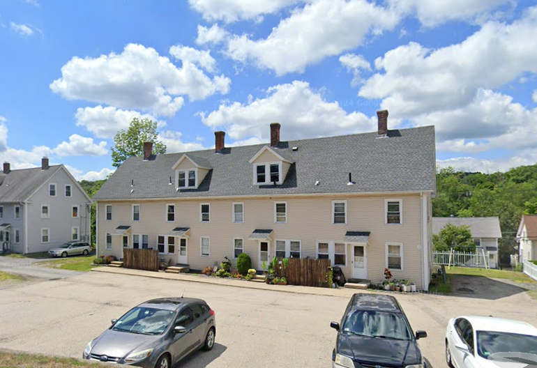 A two-story row house painted beige 