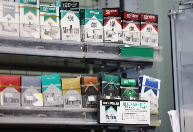 Packs of cigarettes sit on a shelf