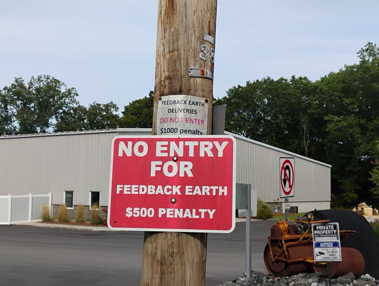 A sign saying "NO ENTRY FOR FEEDBACK EARTH $500 PENALTY"