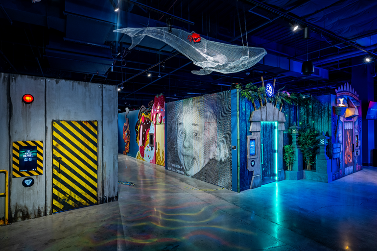Interior of an entertainment venue with walls covered in artwork