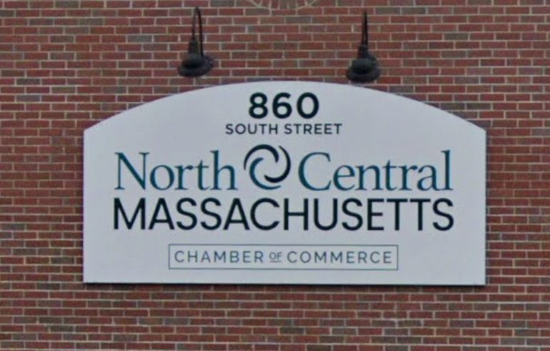 A sign on a brick wall for the North Central Chamber of Commerce