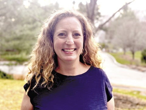Headshot of woman in dark blue dress