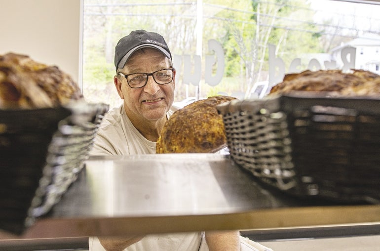 A look at Chuck Brown from behind the bread shelf as he pulls a loaf off. 