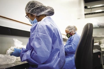 A photo of two BMP Medical technicians wearing scrub uniforms.