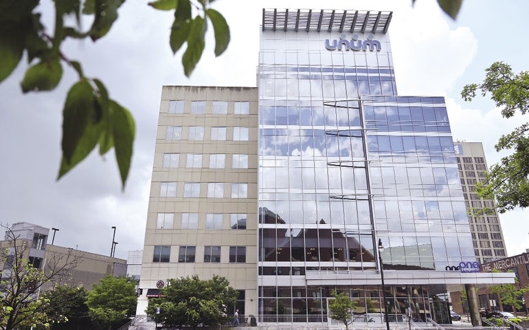 A modern office building with a sign that reads UNUM