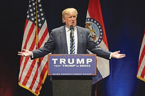 A man stands at a podium in a suit