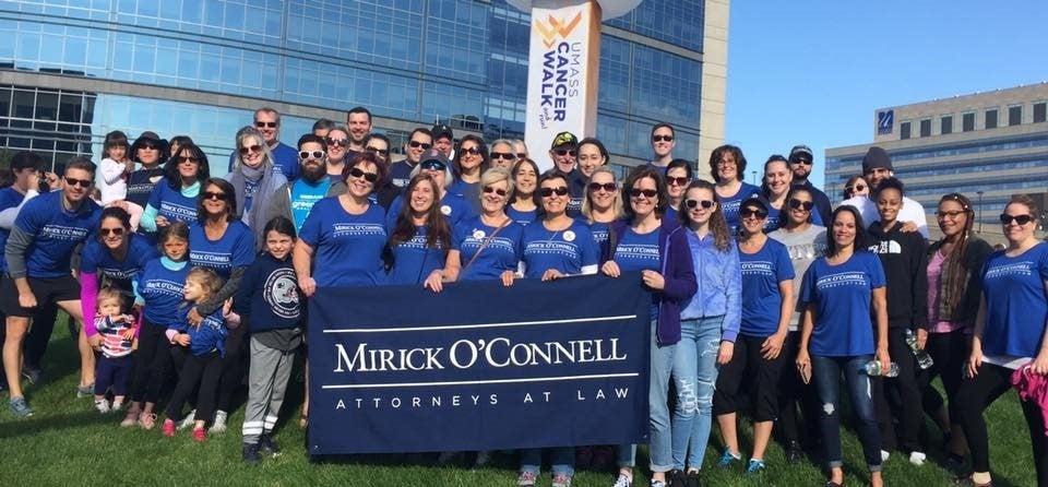 A large group of employees and their families gather for the UMass Cancer Walk.