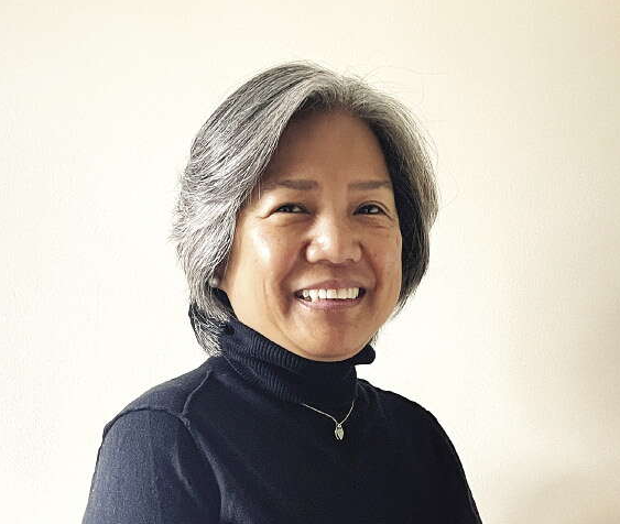 Woman in black turtleneck smiles