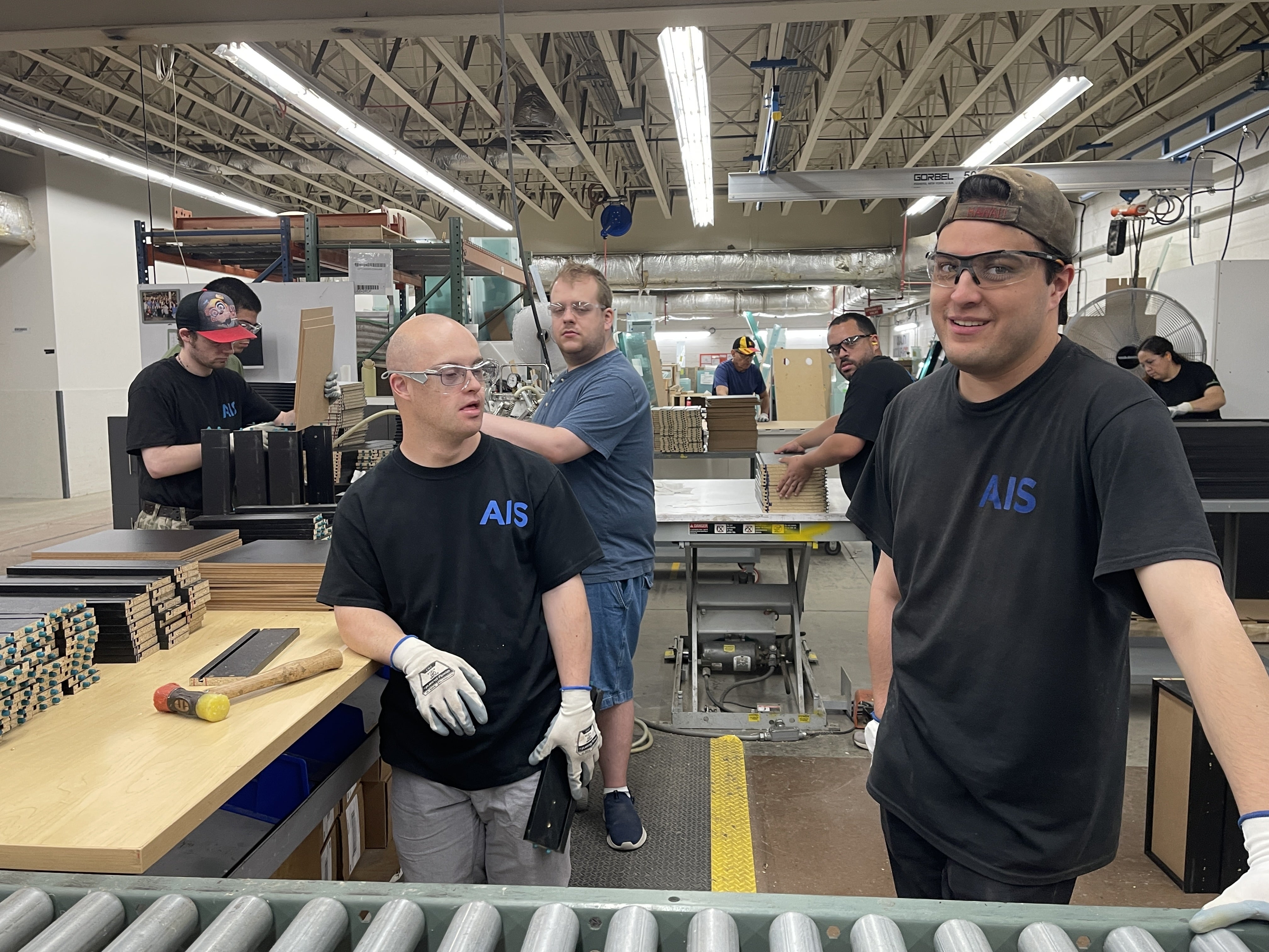 A group of men work inside a warehouse building drawers.
