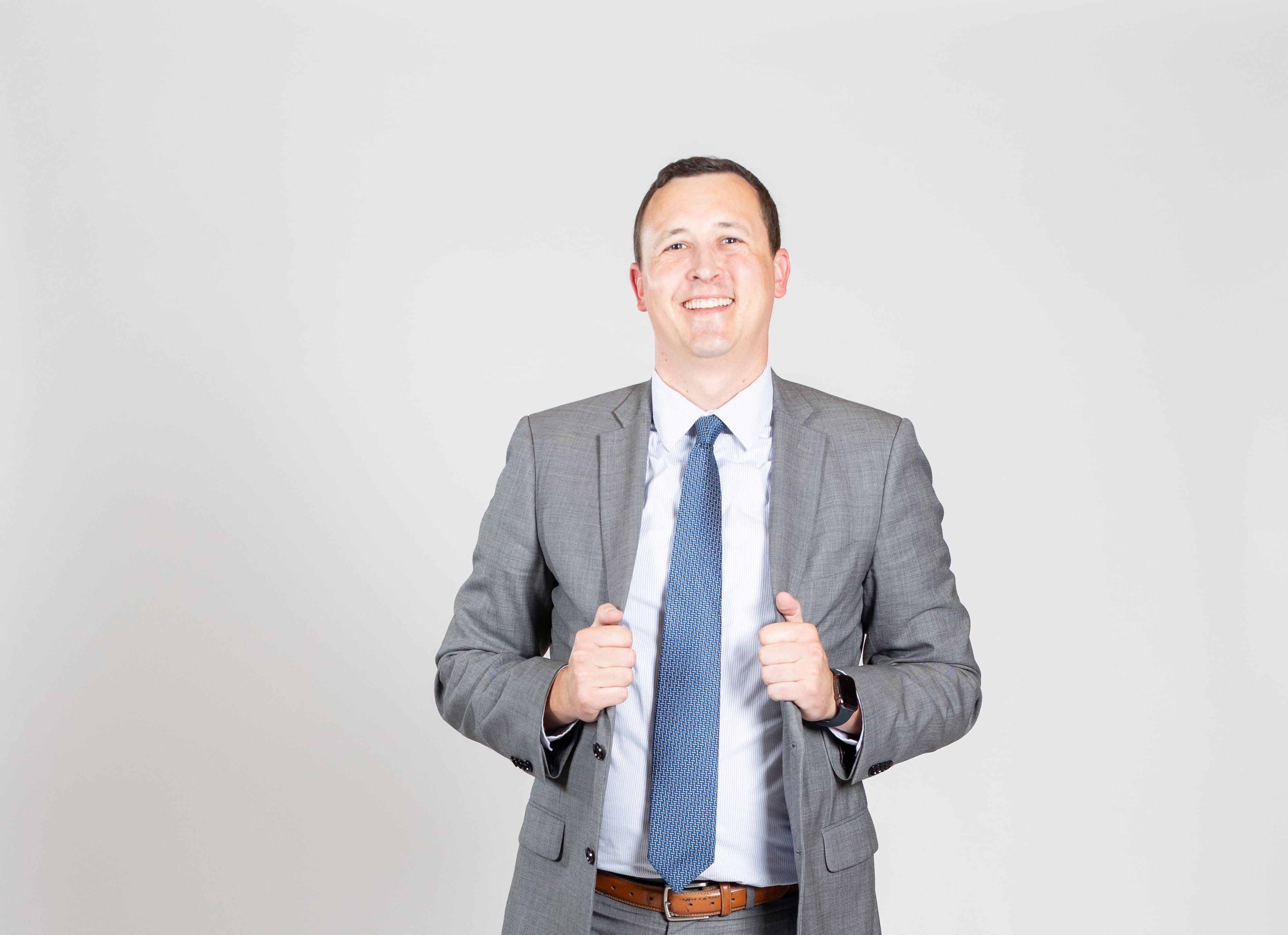 Man in suit smiles