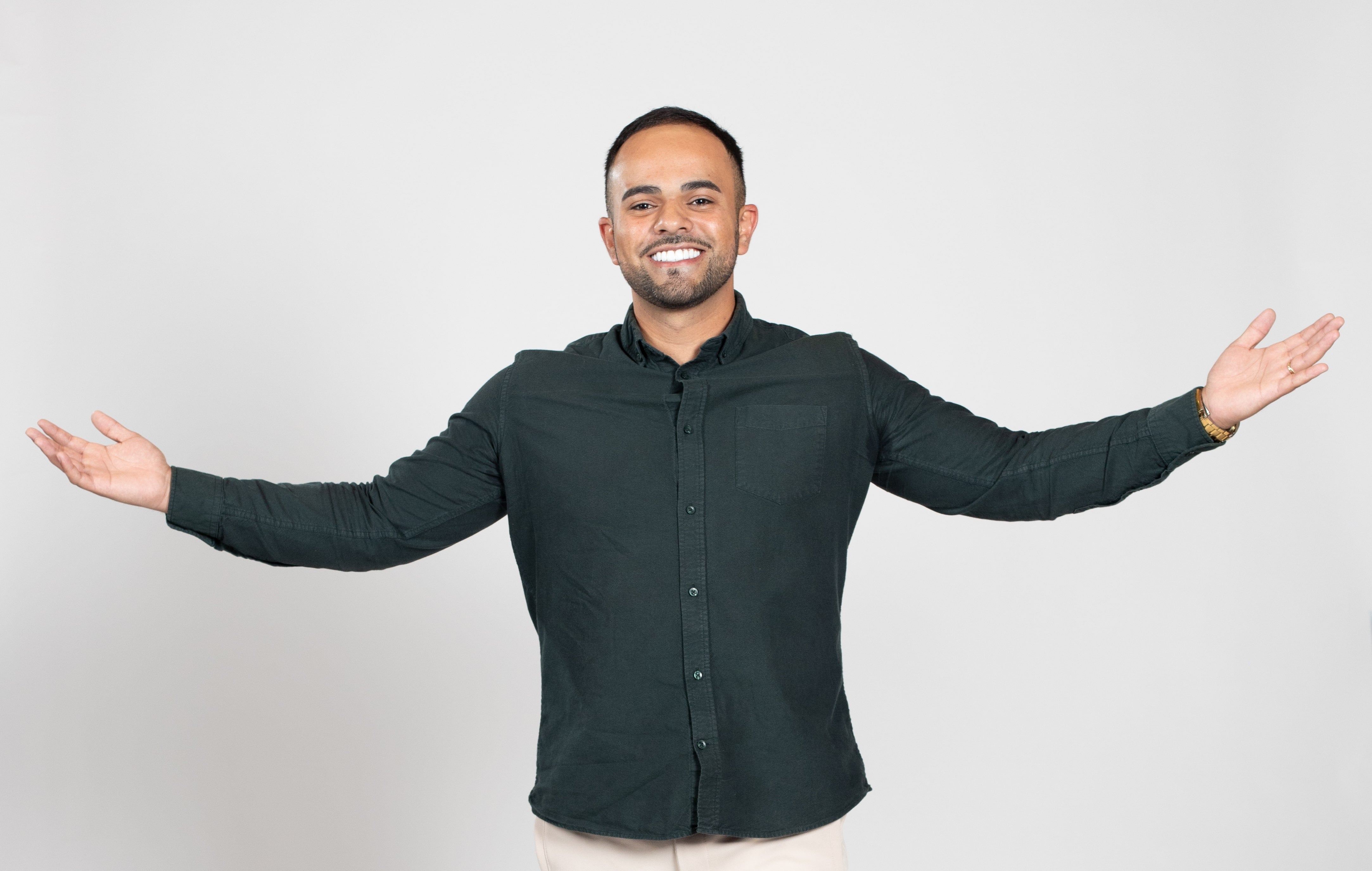 A man in a blue shirt outstretches his arms