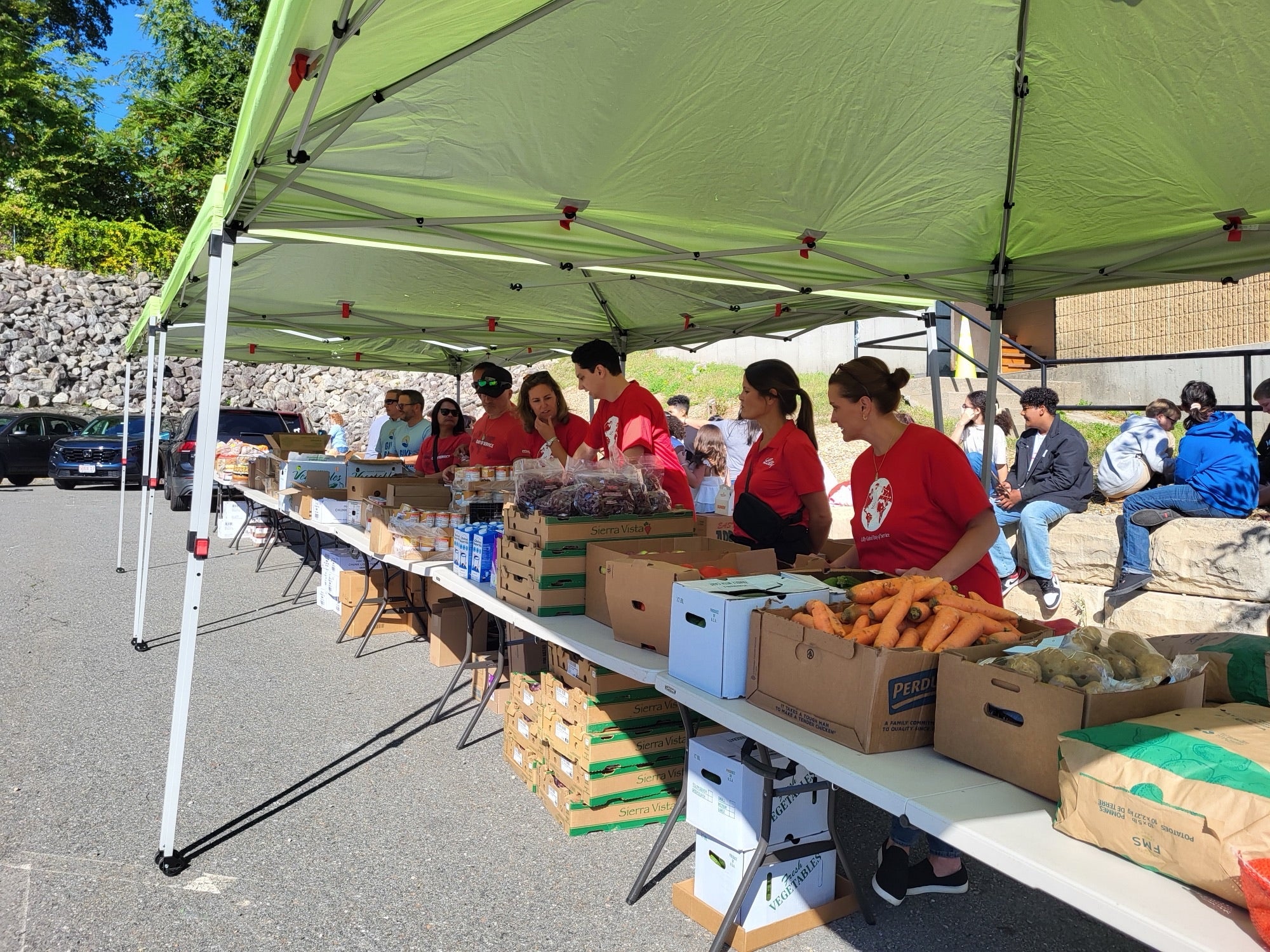 Group of people work a table filled with food items