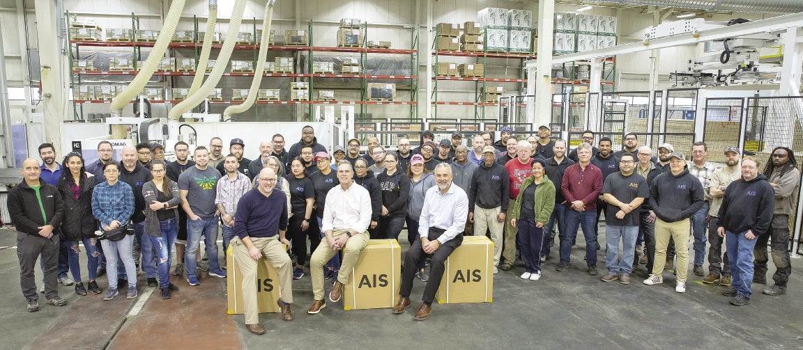 A group of workers standing for a photo